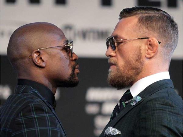 Boxer Floyd Mayweather Jr. [L) and Conor McGregor face off during a media press conference August 23, 2017 at the MGM Grand in Las Vegas, Nevada